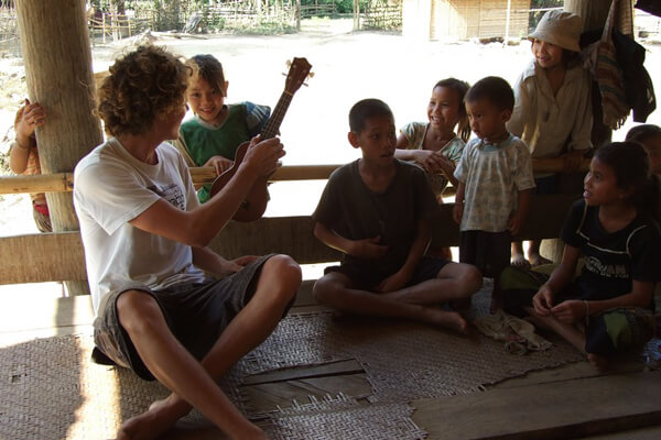 Traveler-playing-with-local-children-in-ethnic, Luang Prabang tour 