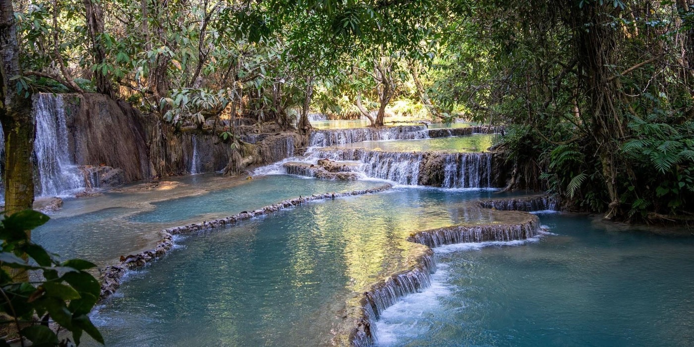 swimming in kuang si falls when in laos tour